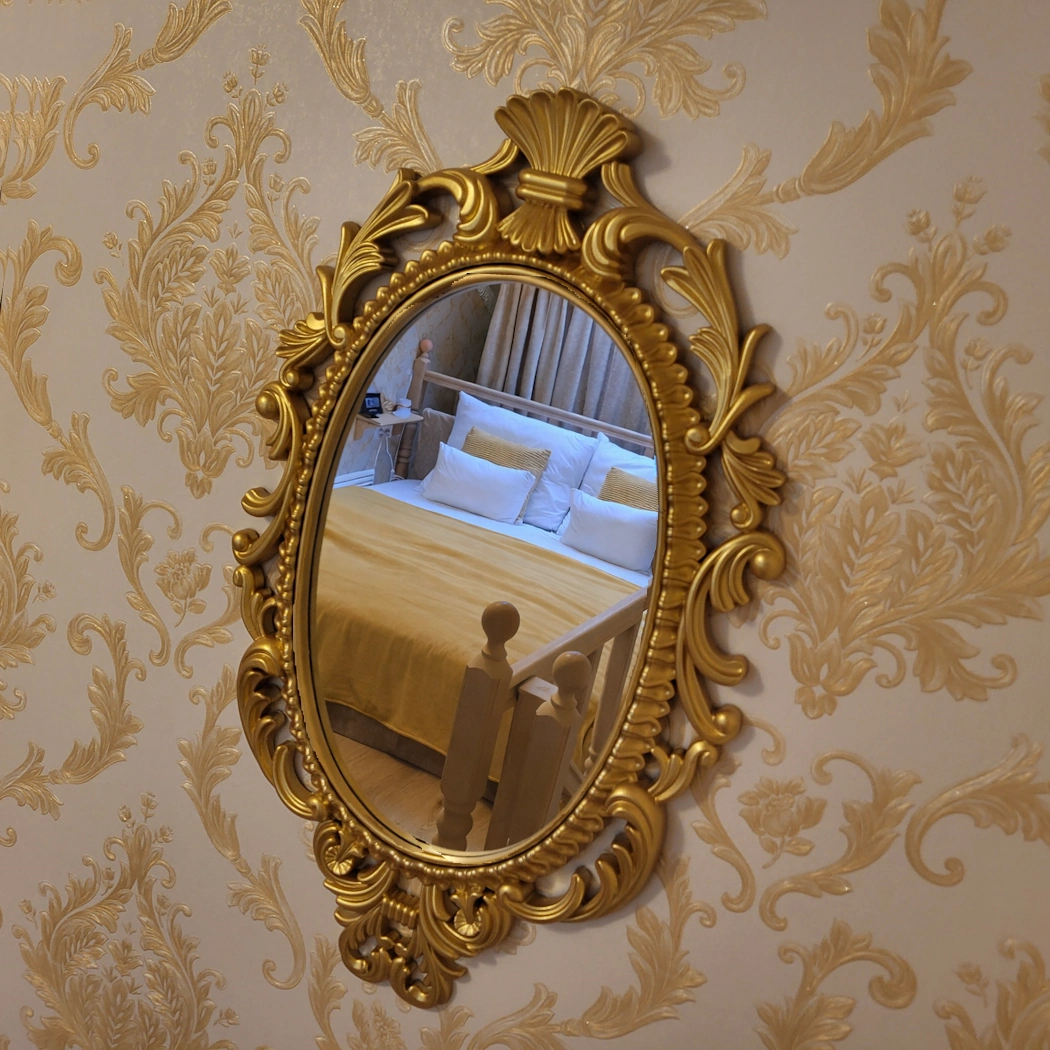 bed seen through golden fancy mirror in loaf