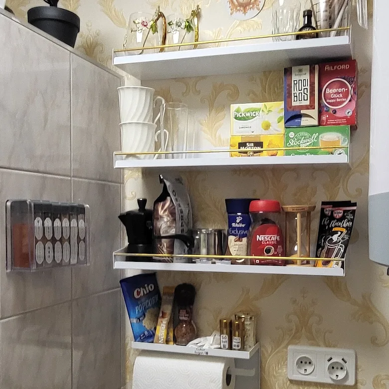Coffee, tea, popcorn and kitchen essentials shelf at Jázmin Apartment Debrecen.