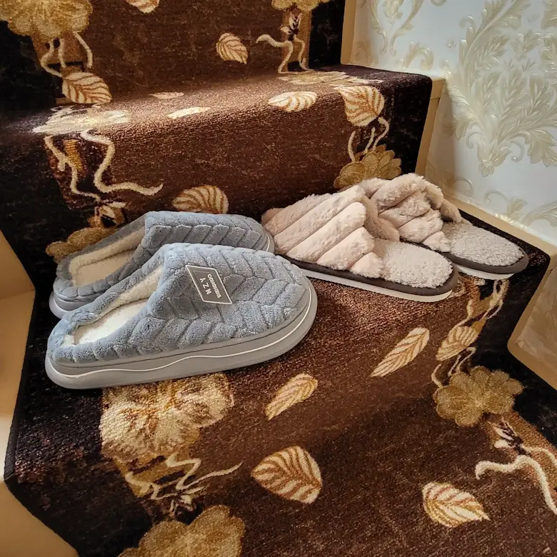 Cozy guest slippers on loft stairs at Jázmin Apartment Debrecen.